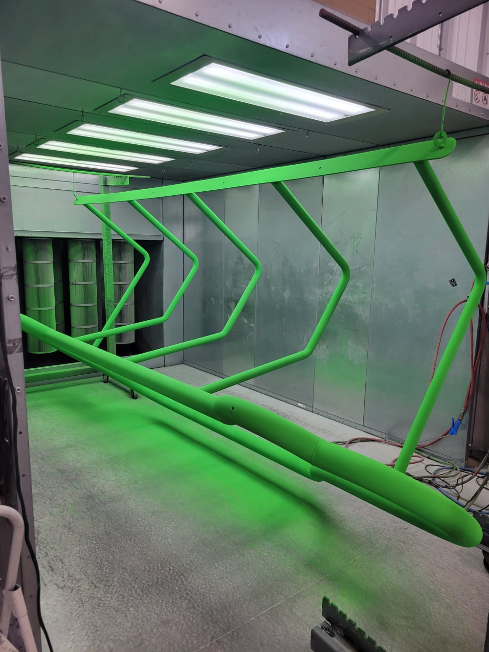 Green Powder Coating in Progress on metal bike stand