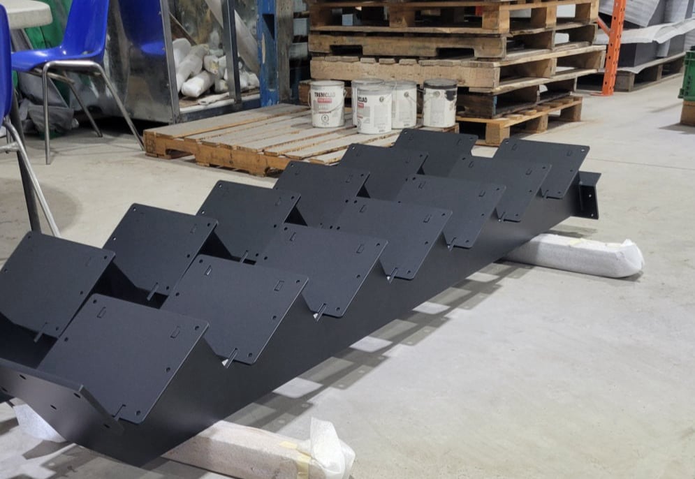 Laser cut and welded metal stairs that have been powder coated in black